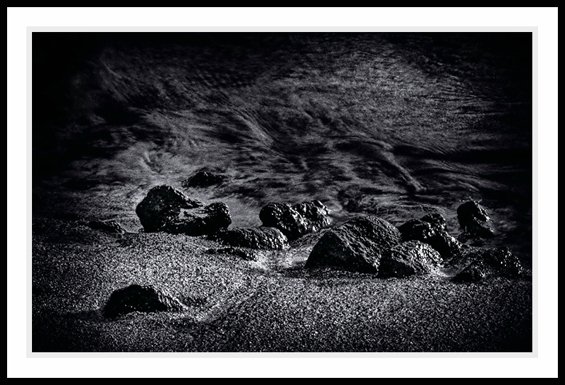 Beach in black and white at night.